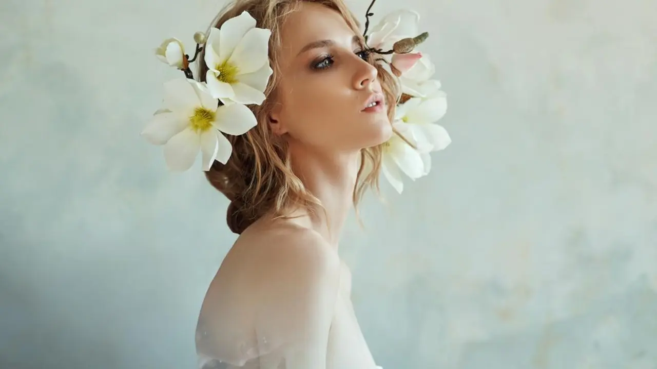 Art Girl blonde flowers near the face. Natural cosmetics for skin care, woman and natural beauty of the skin. Hydration and rejuvenation, anti-wrinkle agent